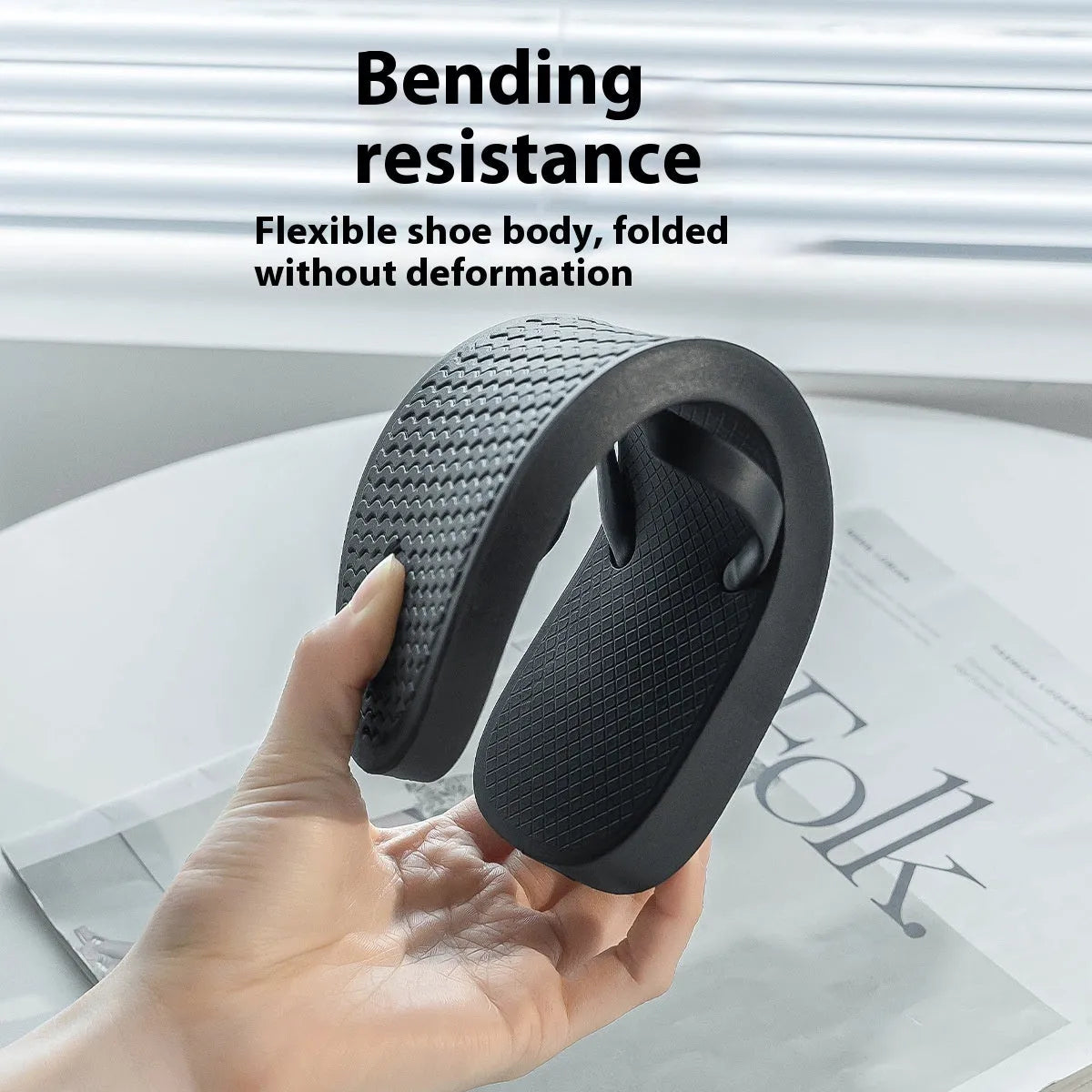 Foldable plastic beach slippers with non-slip sole in black, shown open and folded.