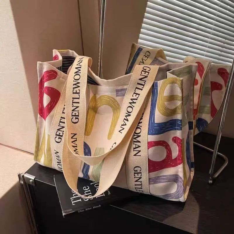 Canvas women's travel tote shopping bag in large capacity format with printing elements