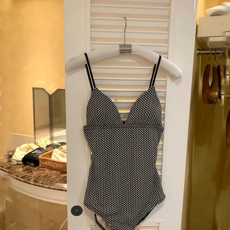 Blue one-piece swimsuit for women with belly coverage, made from polyester.