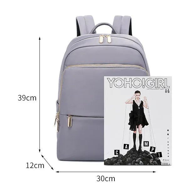 Oxford cloth women's backpack in black and purplish grey, showing large capacity and design features.