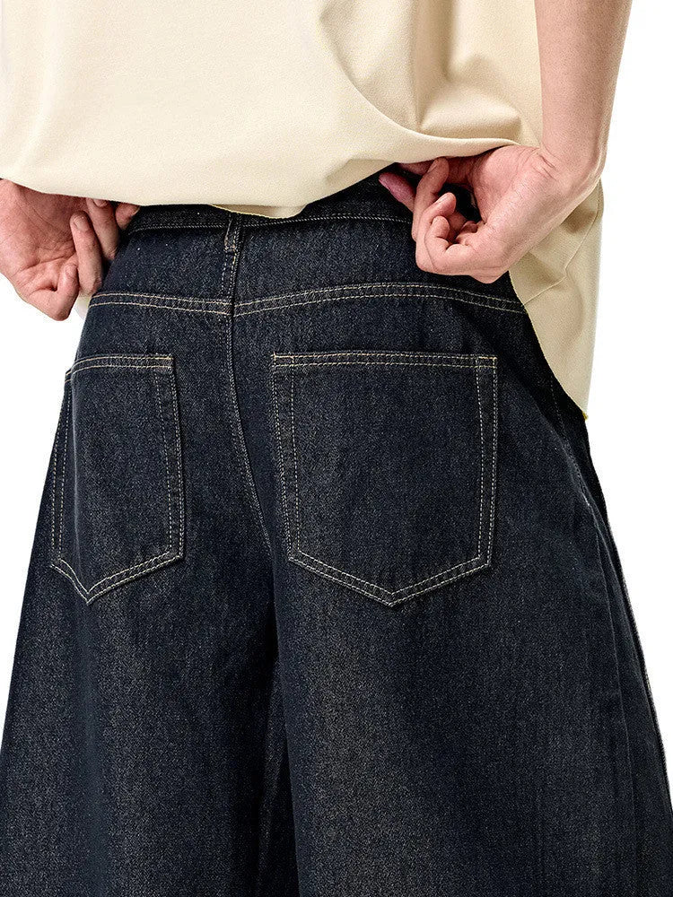Men's original cow colour wide-leg denim trousers laid flat, showing mid-waist and full-length legs.