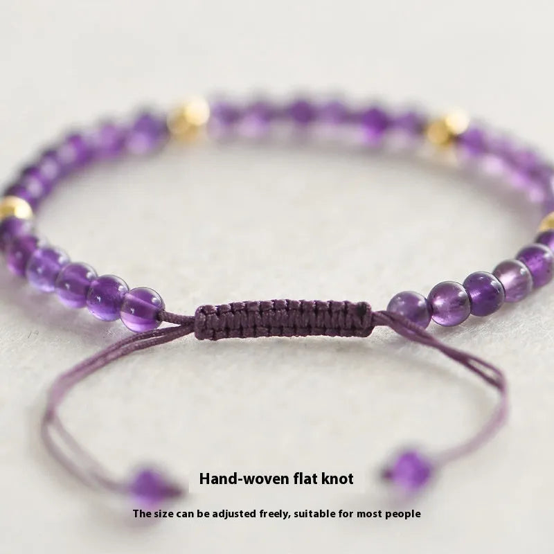 Handmade 4mm natural amethyst bracelet with 14K gold plated accents on a white background