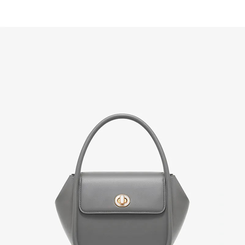 Soft wing-shaped leather cross-body tote bag in cow leather with a buckle and latch closure.