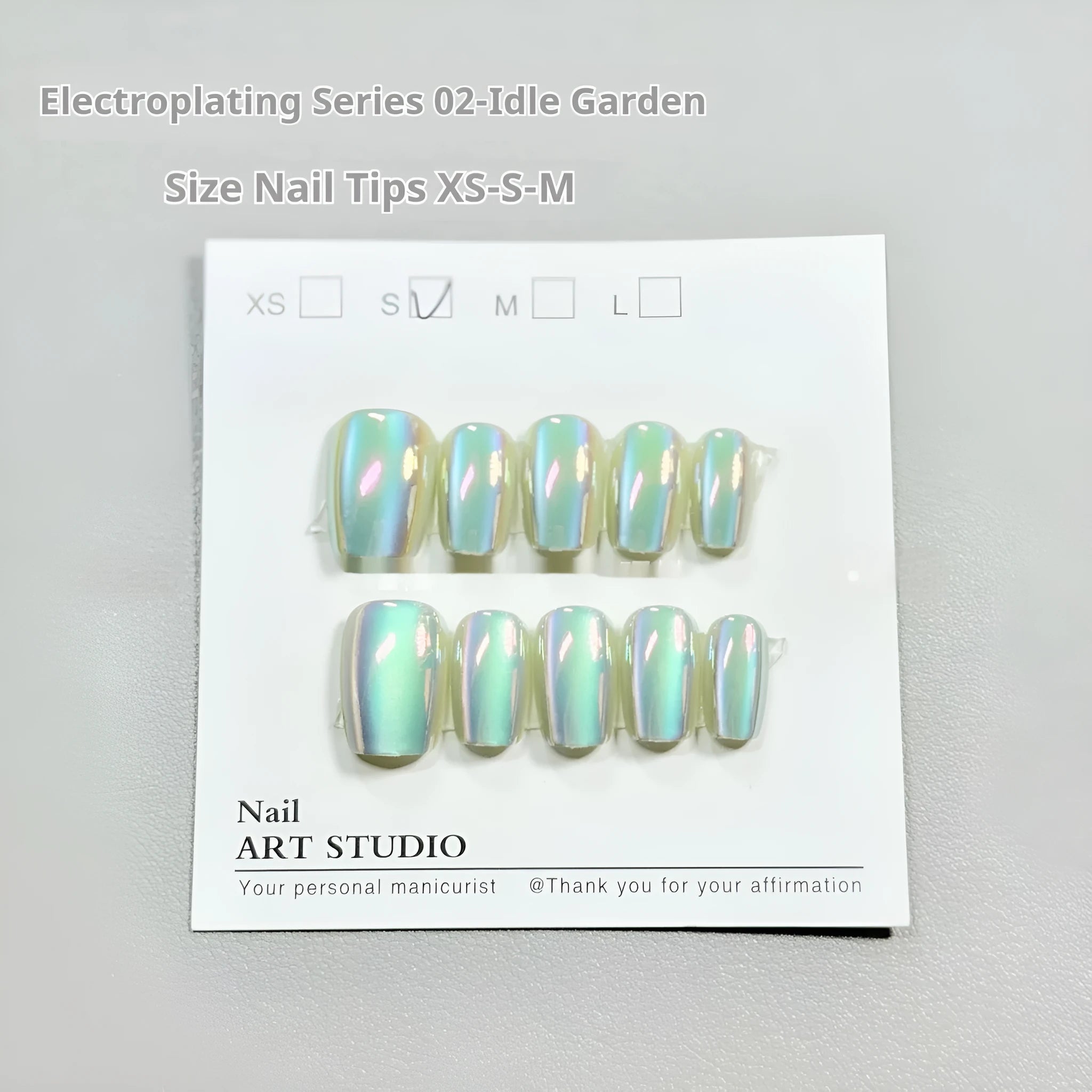 Set of electroplated Cat's Eye false nails in short ladder sizes showing Aurora and solid colour designs.