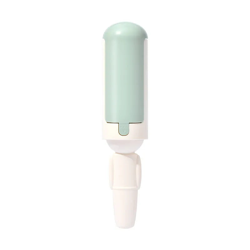 Pet hair remover roller with self-cleaning base, white and green, on a couch