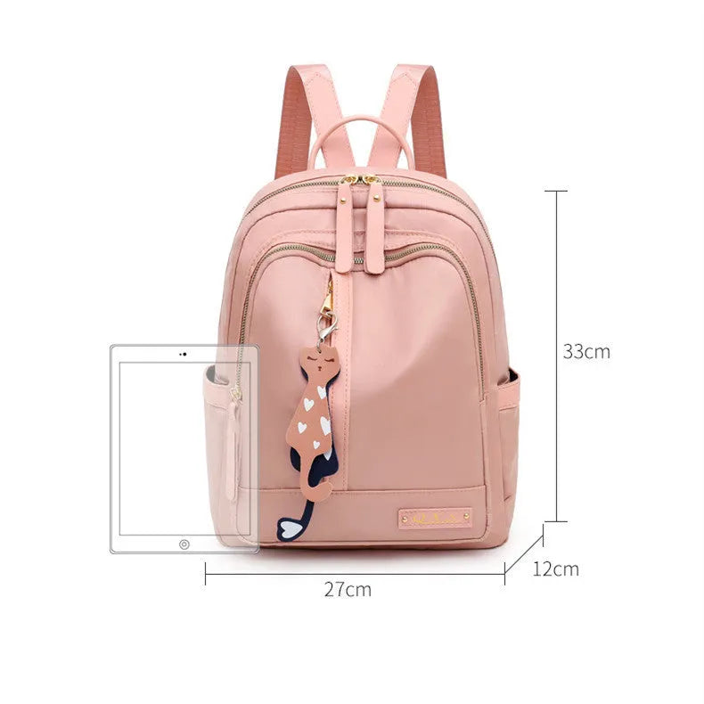 Women's black nylon casual backpack with double shoulder straps, soft handle, and front pocket.