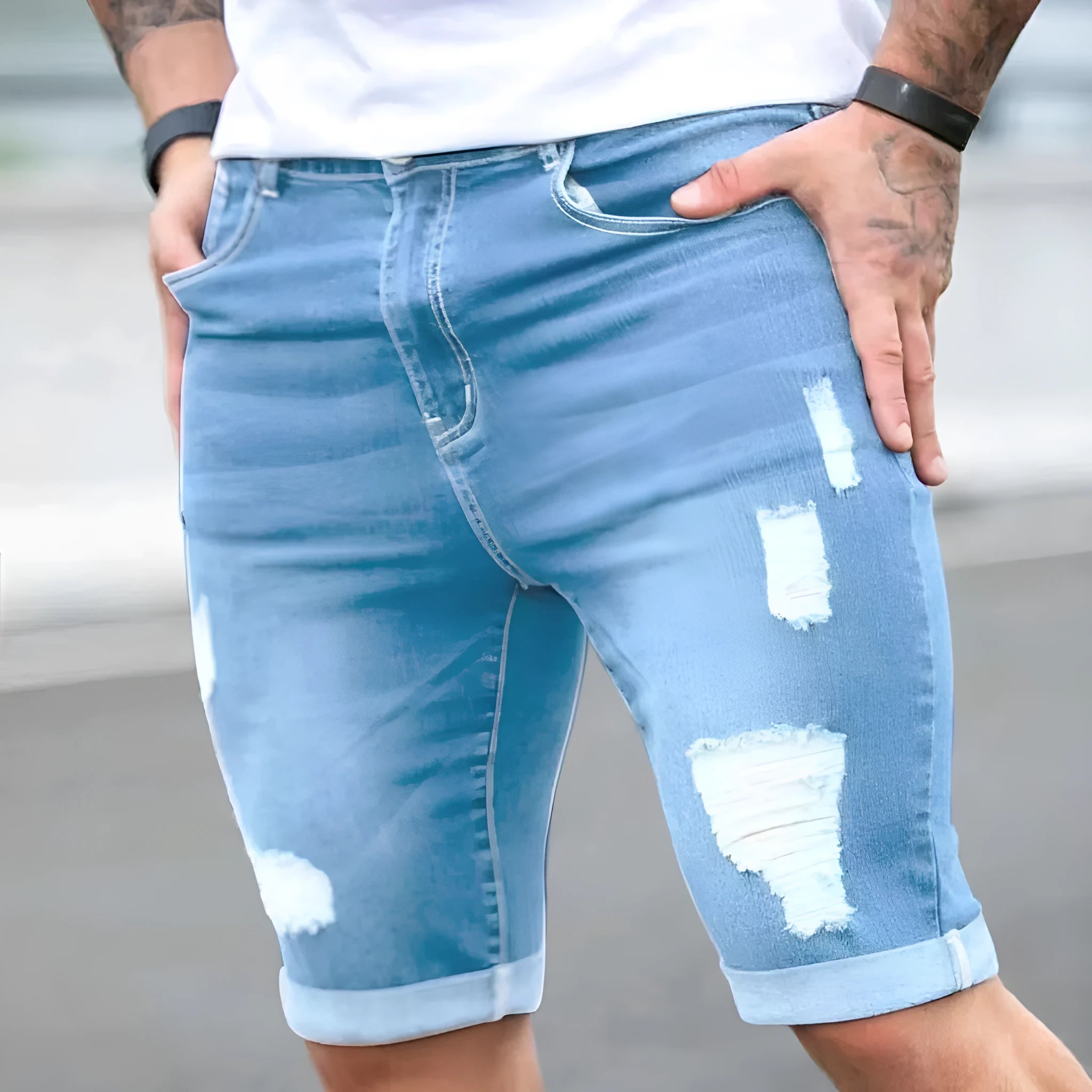Men's sky blue denim shorts with multi-hole design, low waist, straight fit, and zipper fly on a hanger