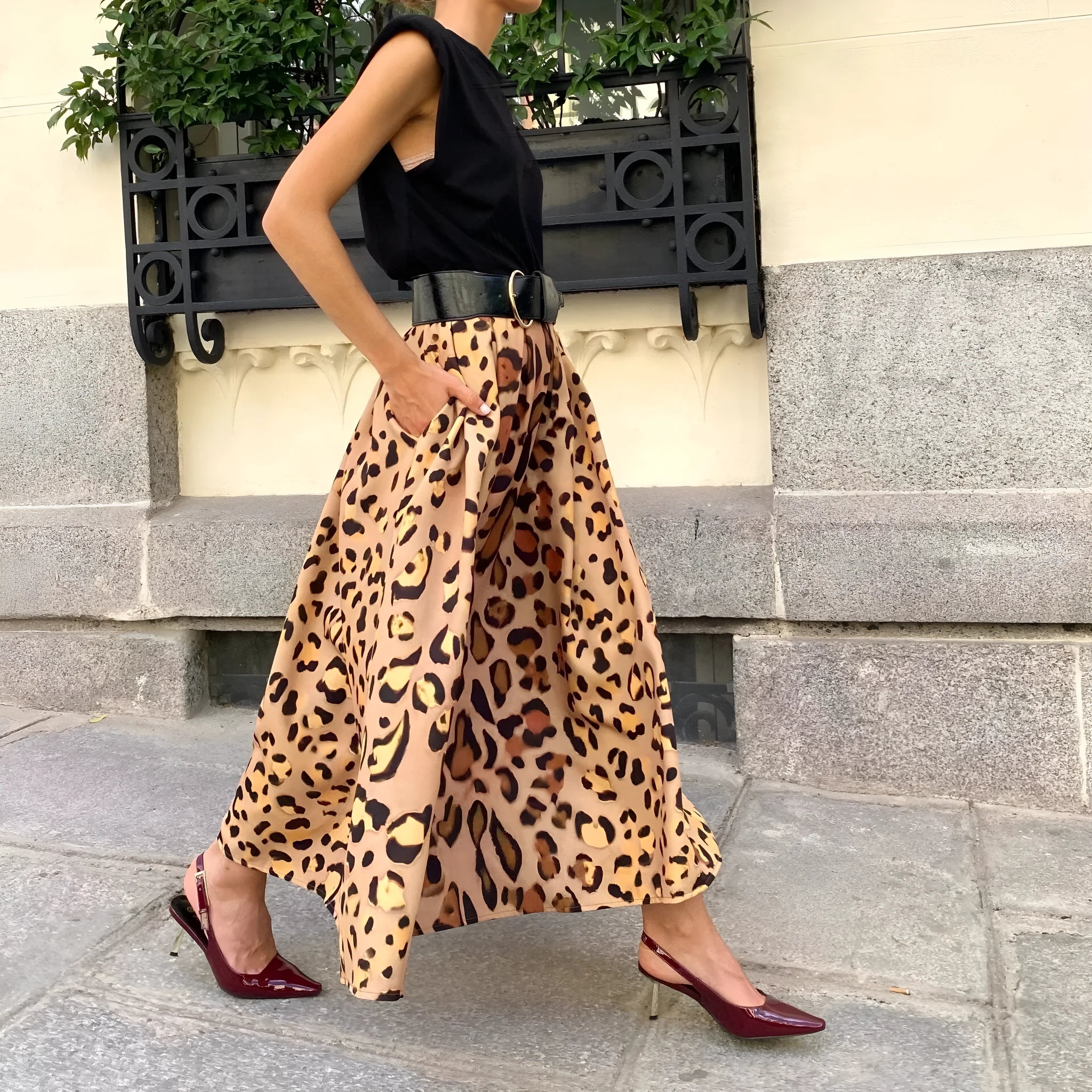 Brown leopard print women's A-line long skirt with a big hem detail on a mannequin.