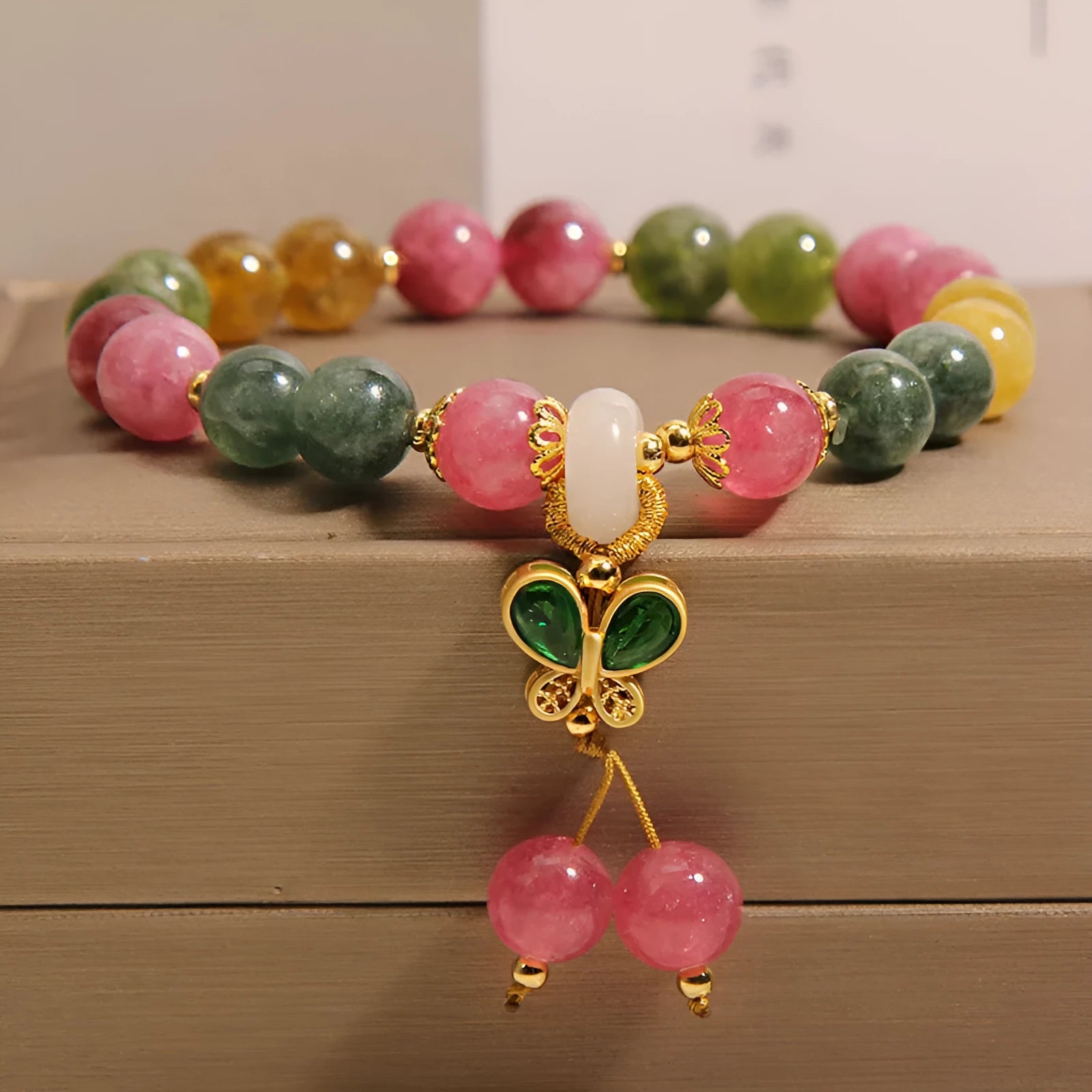 Colourful tourmaline butterfly pendant bracelet with alloy inlay and rhinestone accents on women's wrist