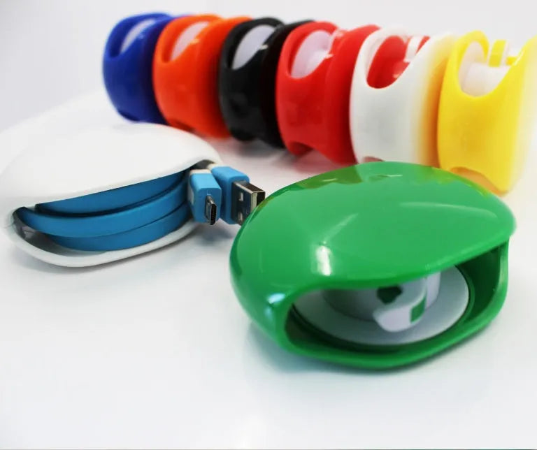 Automatic earphone cable winder retractor in multiple colours showing compact size
