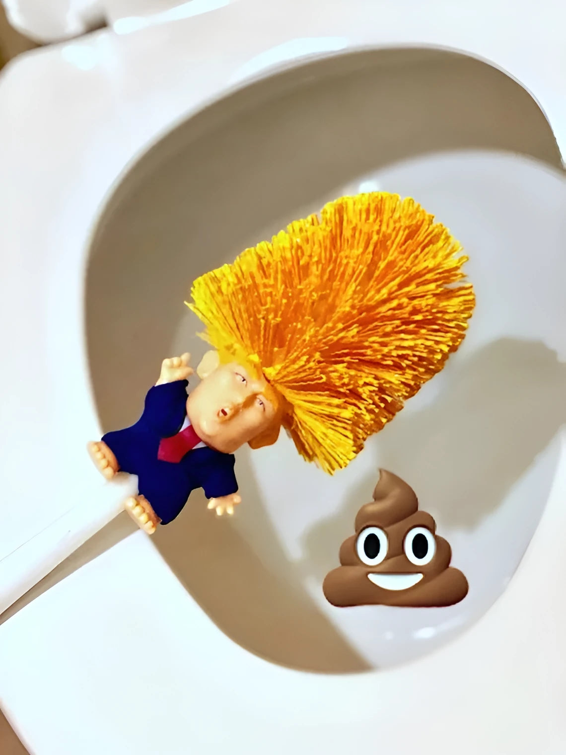 Yellow plastic Donald Trump toilet brush with handle slot, 40cm length, on white background