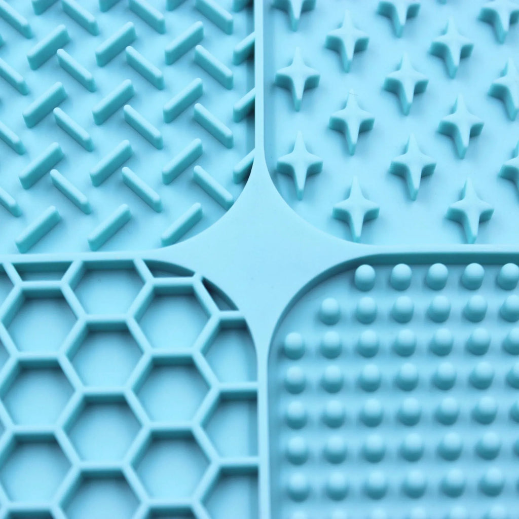 Green silicone pet licking pad 20x20cm with suction cup base on a tiled floor