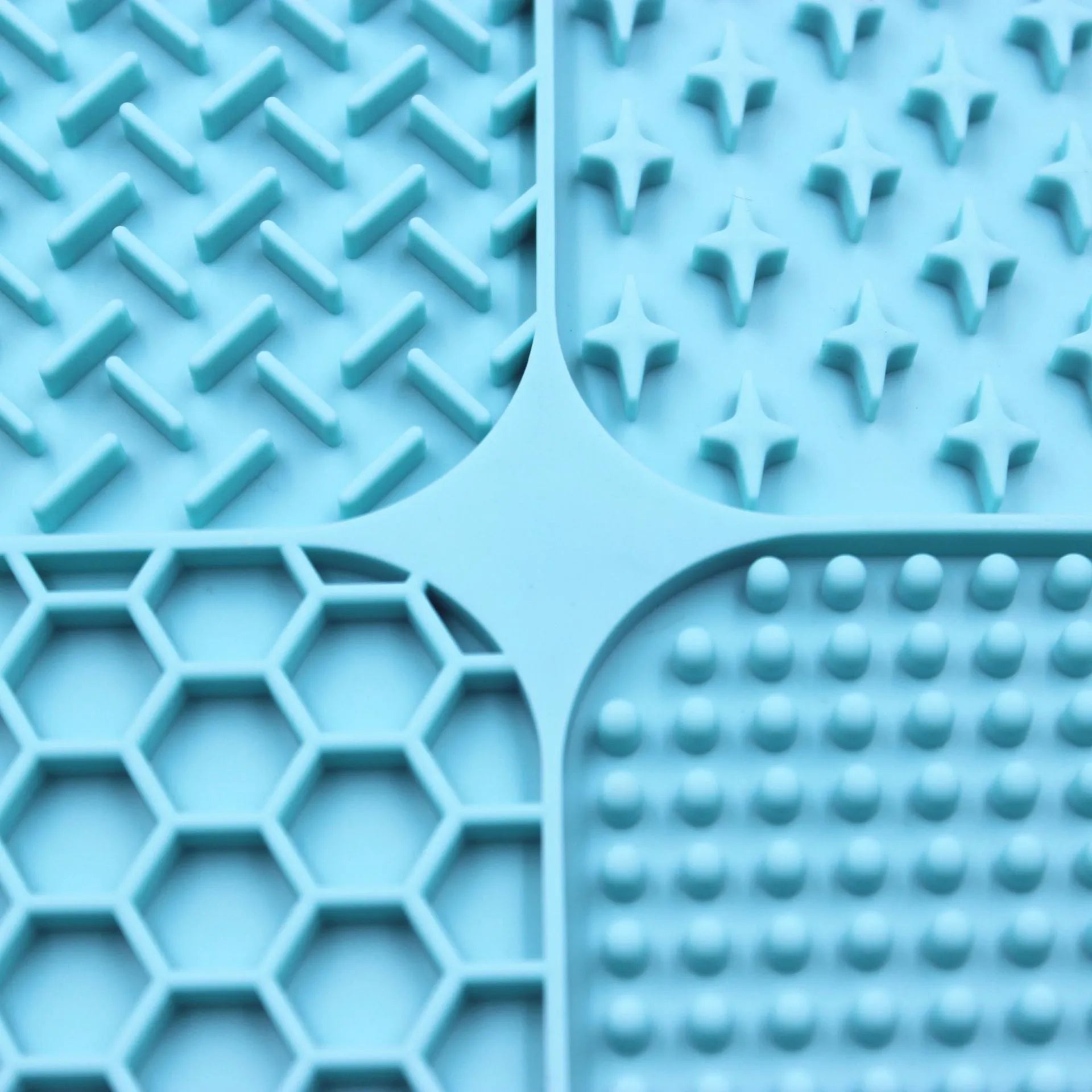 Green silicone pet licking pad 20x20cm with suction cup base on a tiled floor