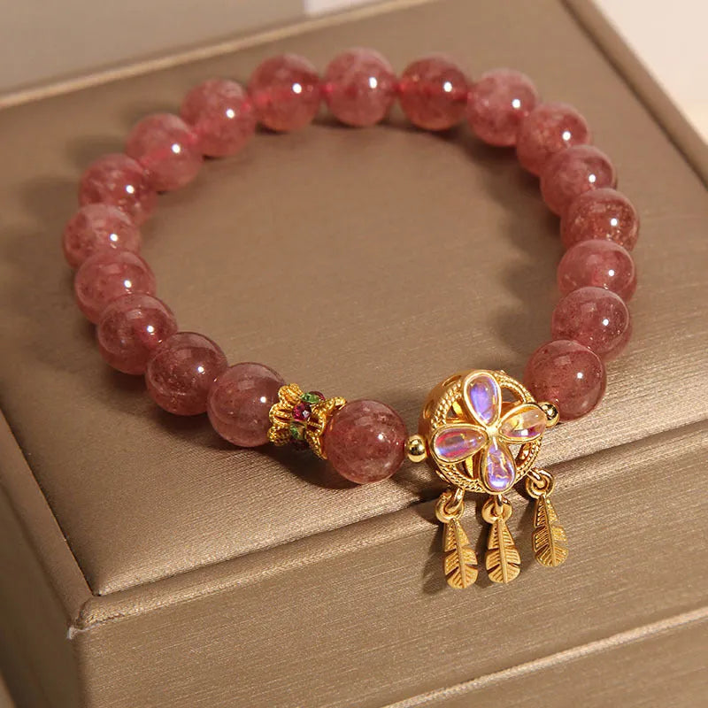 Women's strawberry quartz bracelet with four-leaf clover dream catcher pendant and silver ball charms