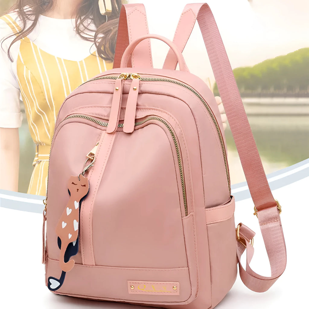 Women's black nylon casual backpack with double shoulder straps, soft handle, and front pocket.