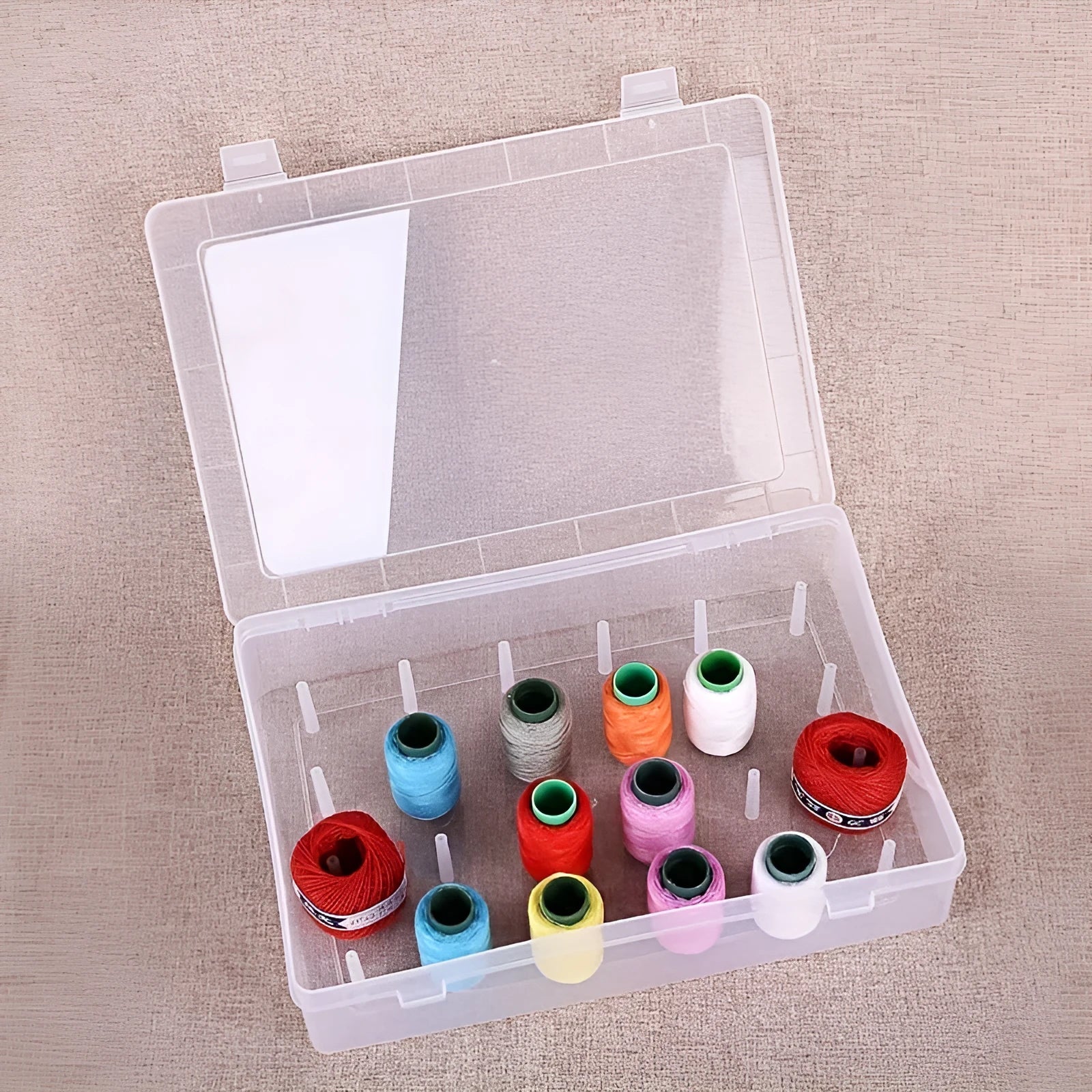 Transparent plastic box with 42 small compartments for organising sewing needles and pins.