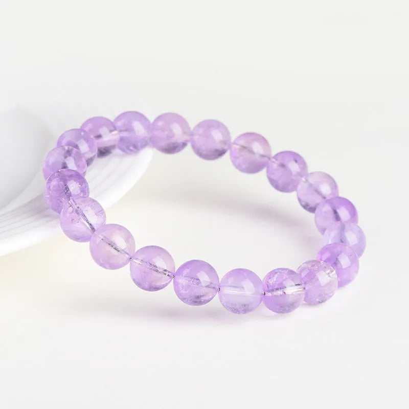 Lavender amethyst crystal bracelet with round beads showing water ripple pattern in light purple colour