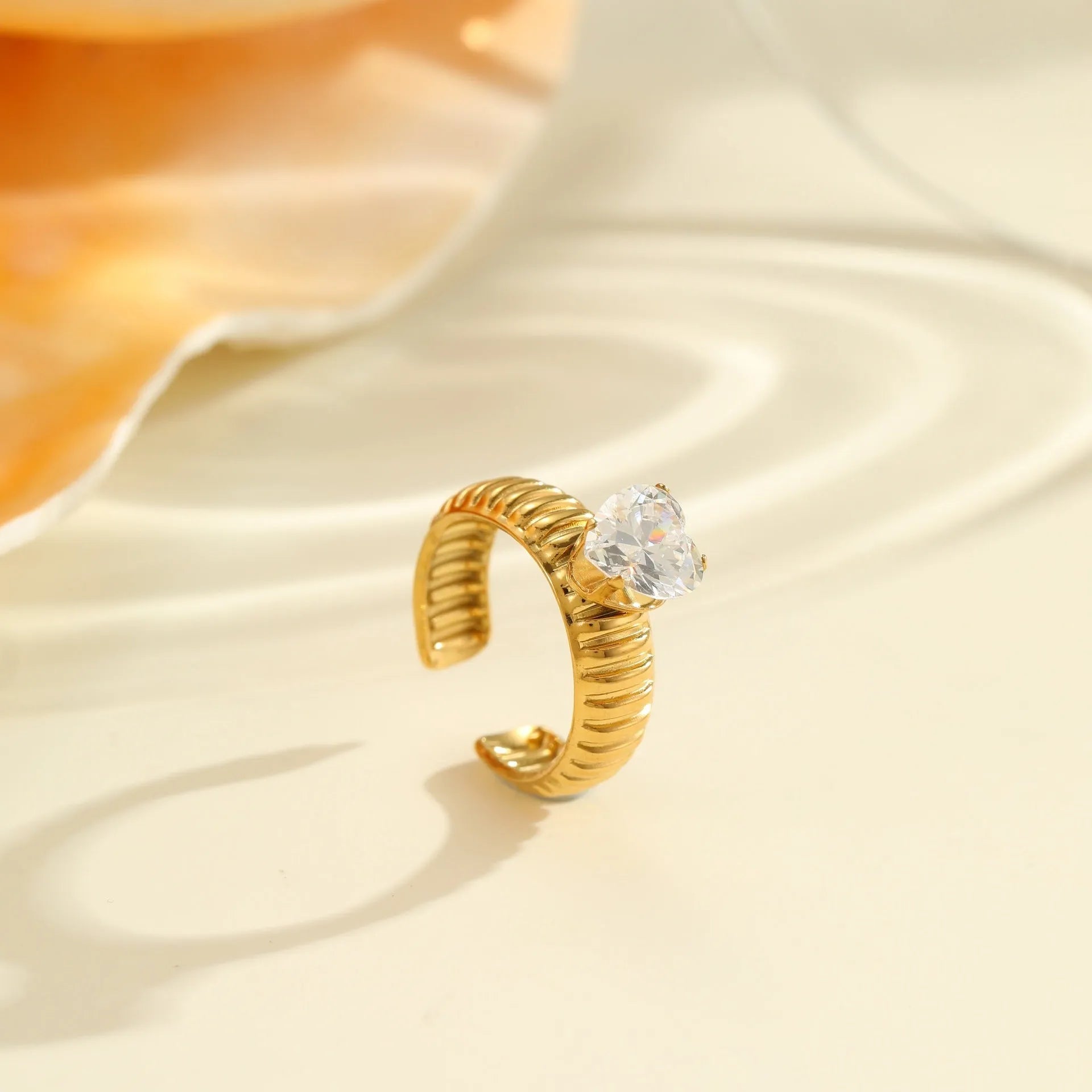 Women's gold stainless steel ring with zircon details on heart and drop shapes