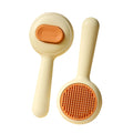 Green and yellow cat grooming brush with stainless steel teeth and a non-slip handle.