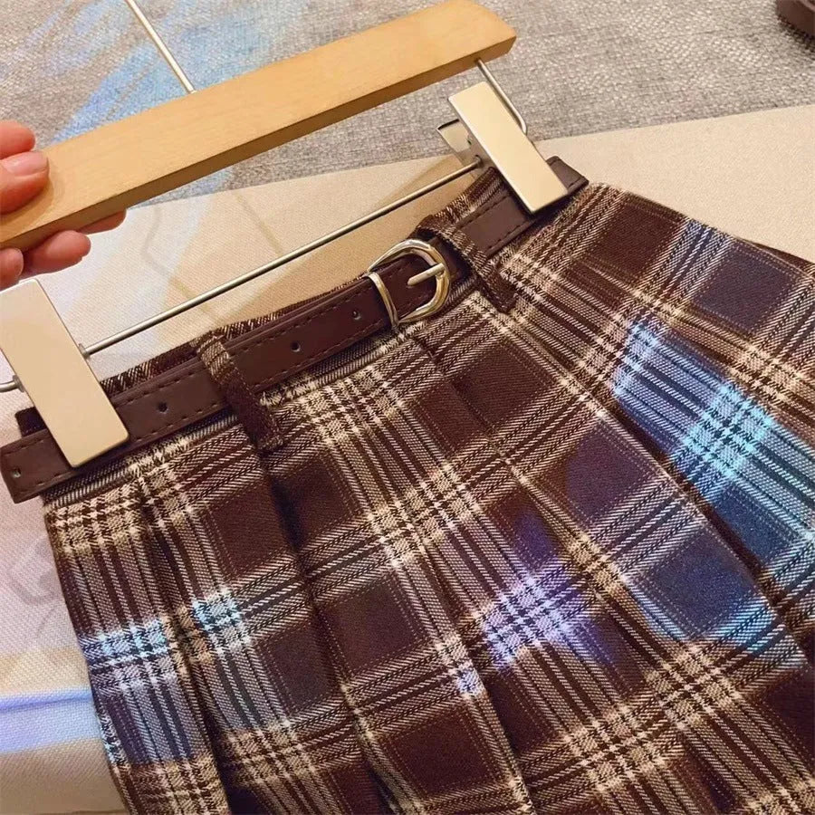 Girls red and black plaid pleated A-line skirt made from cotton blend fabric.