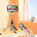 Selfie stick with aluminium alloy body and phone holder in tripod mode on a desk