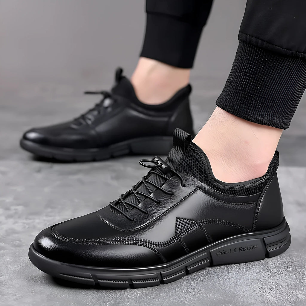 Men's black low heel casual shoes with round toe and square heel on a plain background