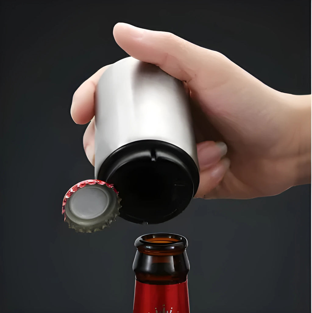 Stainless steel automatic beer bottle opener with press mechanism and magnetic cap catcher on a table