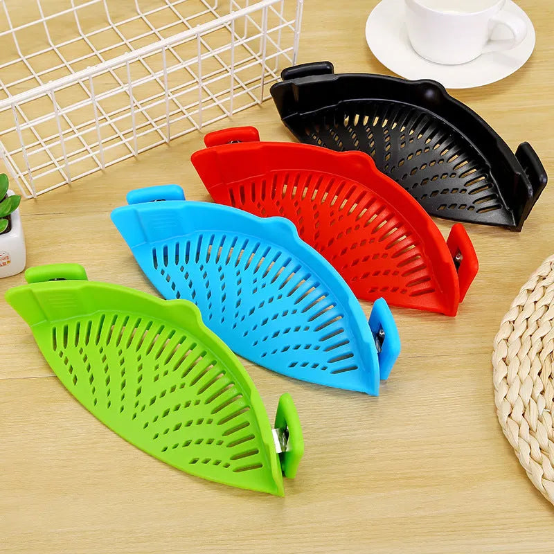 Silicone clip-on pot strainer with uniform hollow design in Red, attached to a stainless steel pot rim