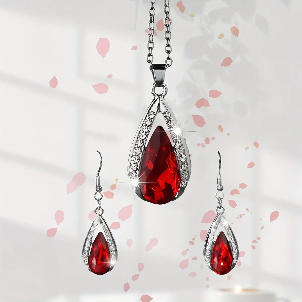 Teardrop pendant necklace and matching earrings set in black or red alloy with water droplet design elements
