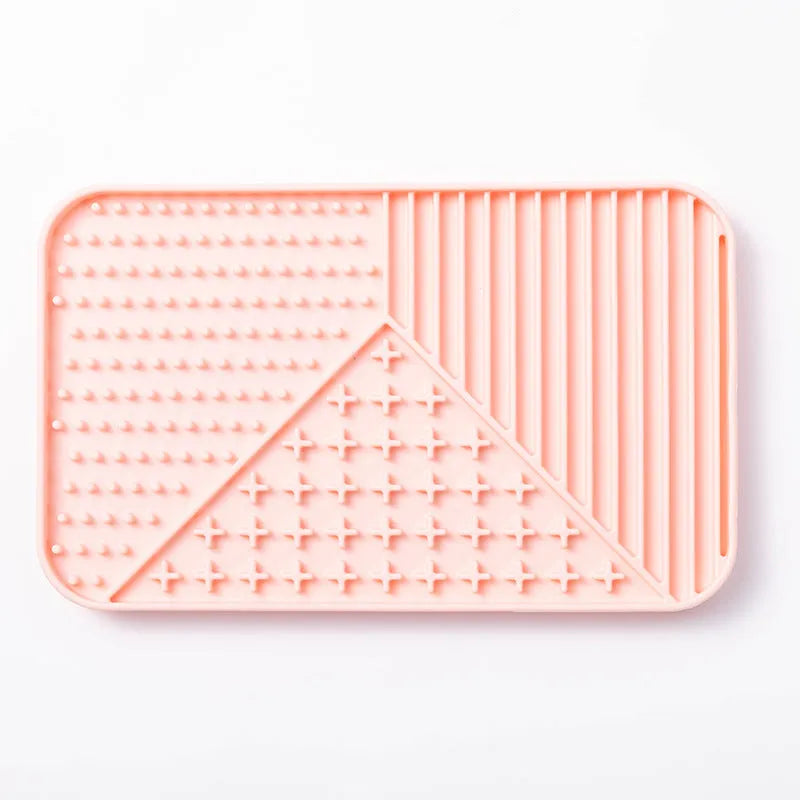 Silicone pet licking mat in khaki with suction cups on a tile floor for slow feeding