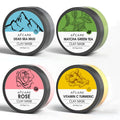 4 pack of Dead Sea mud, green tea, turmeric and rose clay face masks in 80ml pots on white background