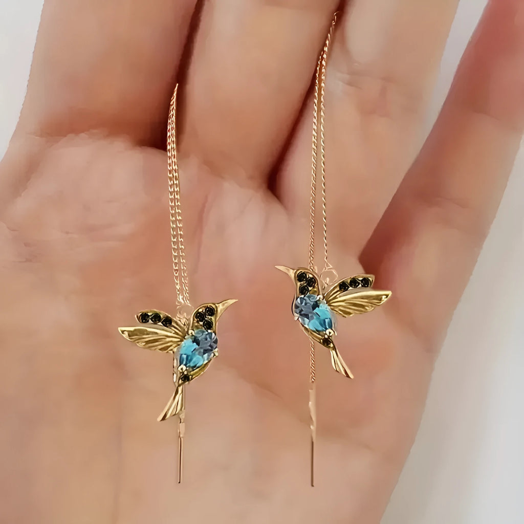 Women's long hanging earrings with bird charm design featuring zirconium wings in blue, red, and red lvzuan colour options
