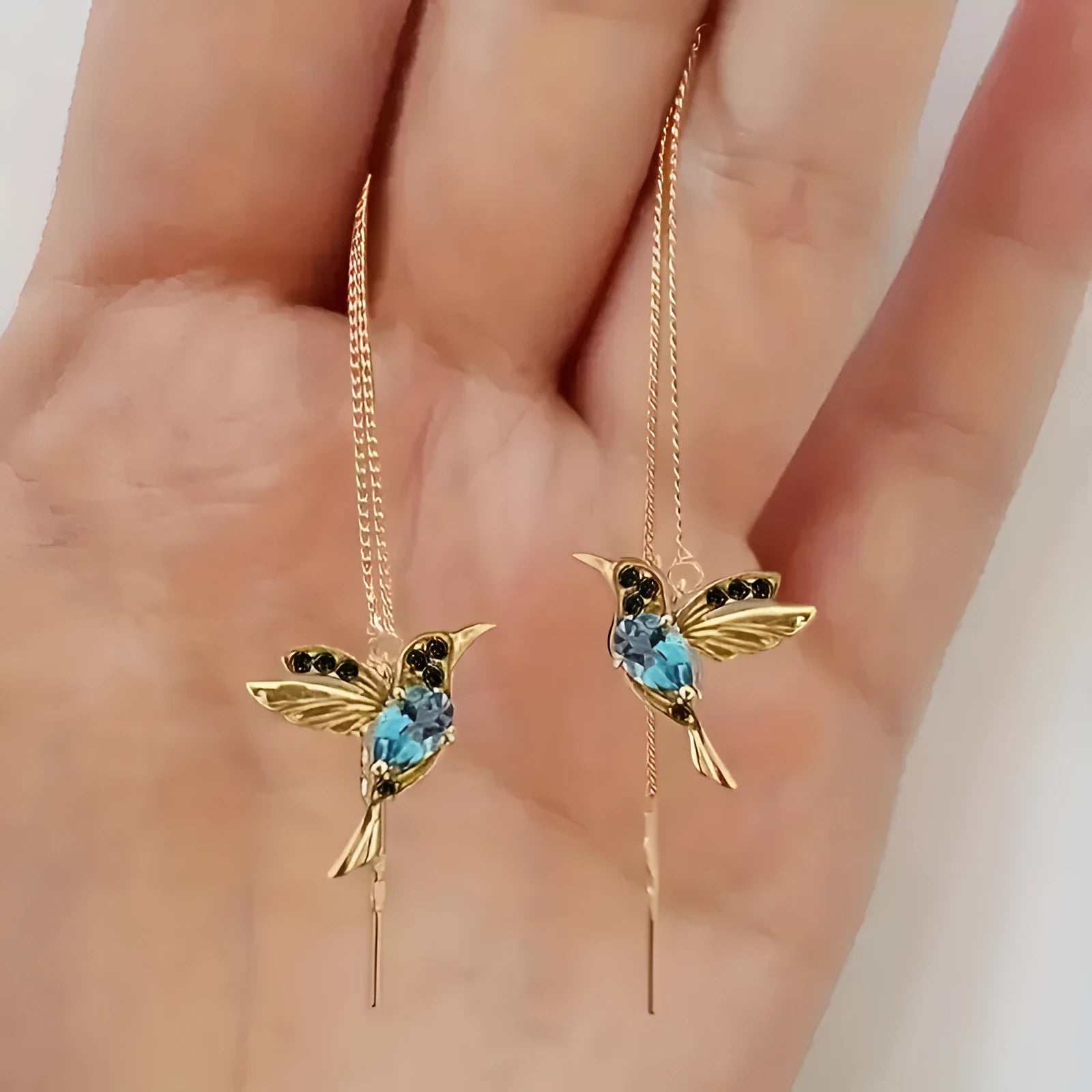 Women's long hanging earrings with bird charm design featuring zirconium wings in blue, red, and red lvzuan colour options
