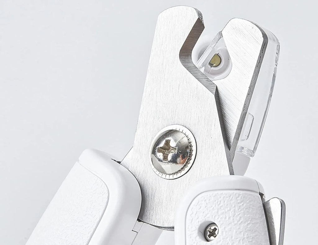White pet nail clippers with LED light, transparent anti-splash guard, and a leather-like handle.