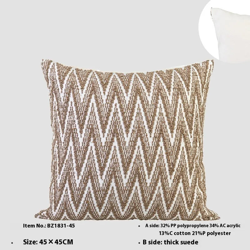 Chinese style square cushion with geometric pattern in Maillard brown colour on a sofa.