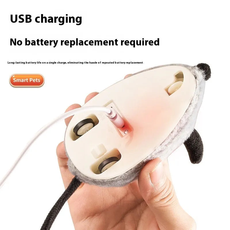 Intelligent charging simulation electric little mouse cat teaser toy in gray with double tail decoration on a light surface