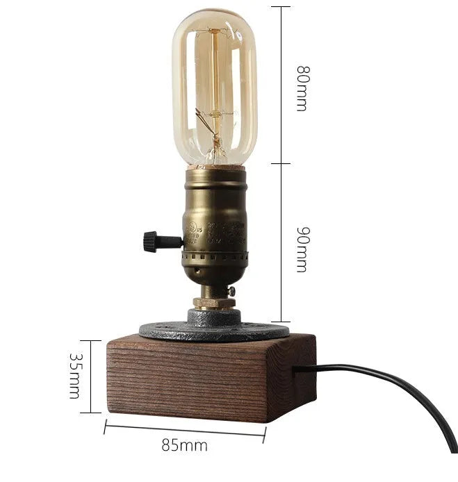 Compact wooden and iron water pipe design table lamp on a table.