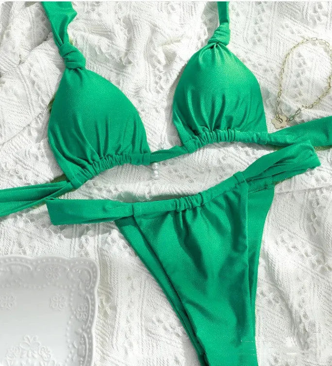 Women's pink bikini with pleated split straps tied in a knot, showing the briefs style.