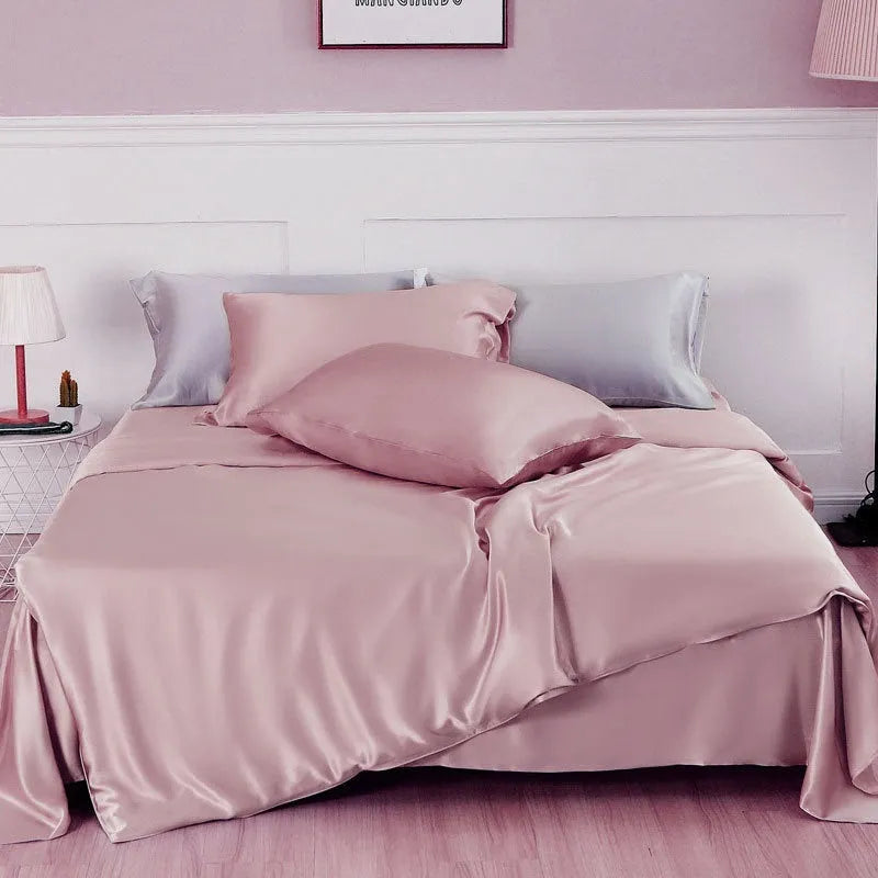 Solid colour silk duvet cover in Lotus Pink showing plain weave texture on a bed.