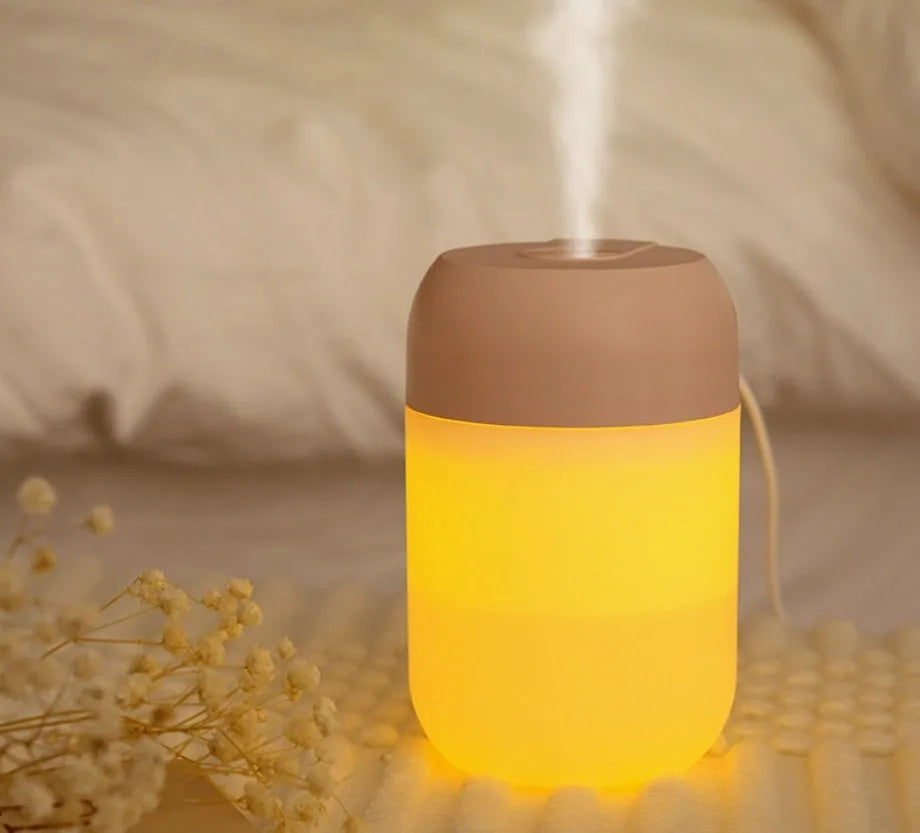 Small white cylindrical USB-powered humidifier with aromatherapy function on a desk