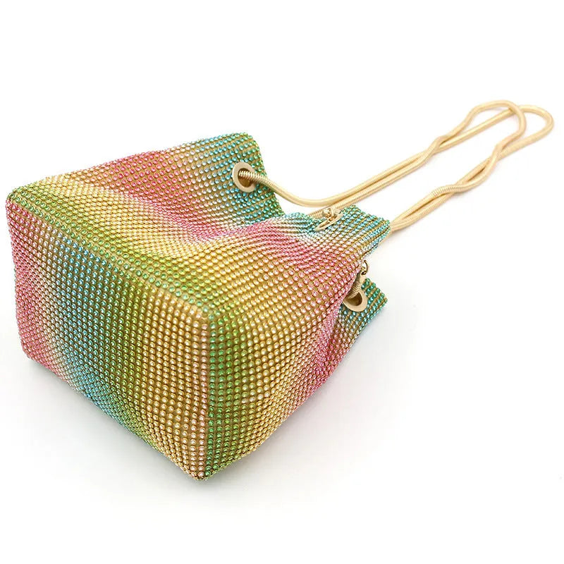 Rainbow coloured rhinestone bucket bag for women with adjustable fabric strap.