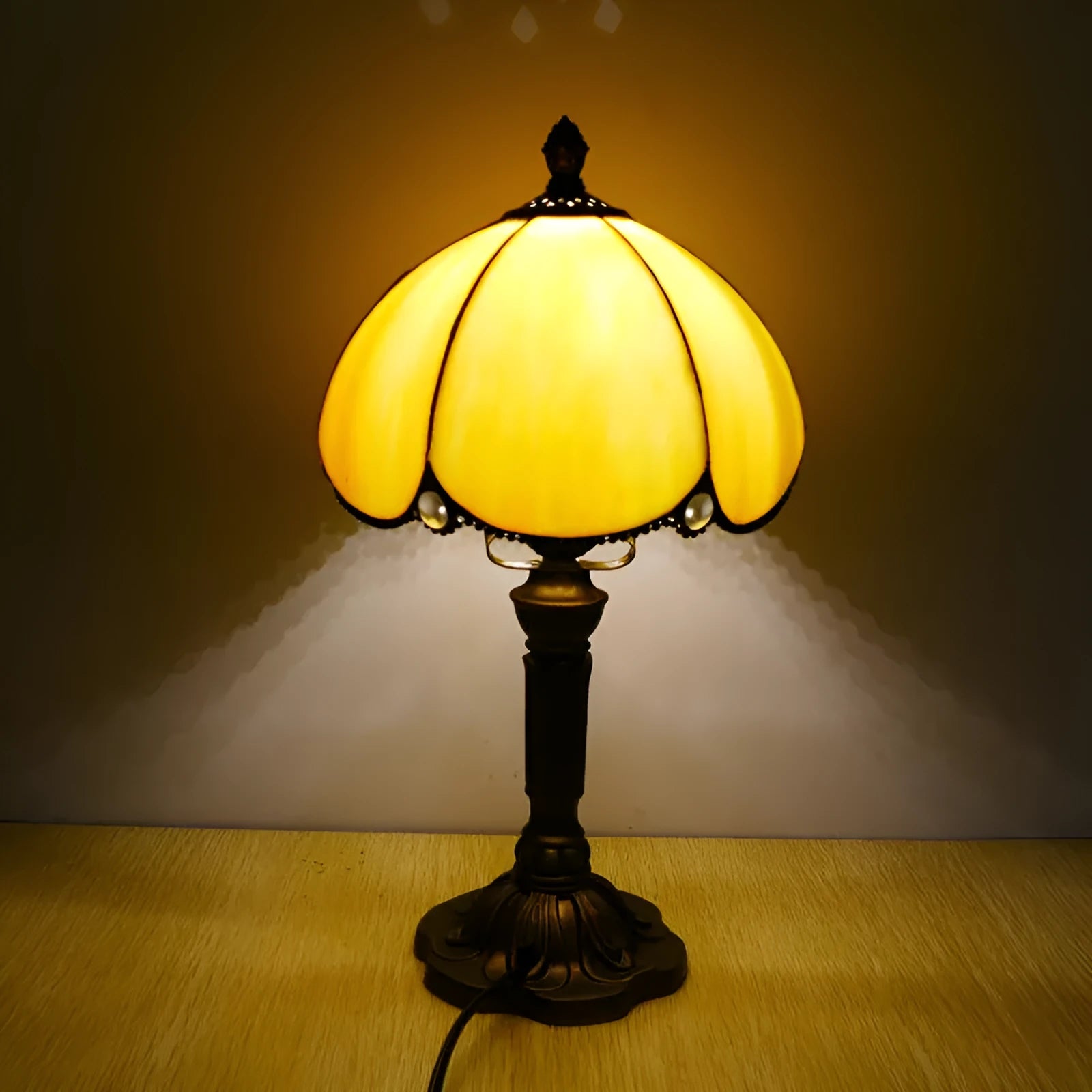 Beige simple modern creative art bedside lamp 20cm width on a bedside table