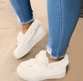 Women's white cotton slip-on indoor shoes with round toe and non-slip rubber sole.