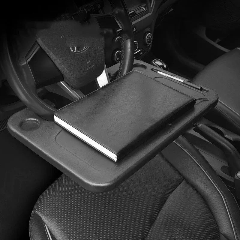 Black plastic car computer desk and dining tray measuring 42 x 28cm on a car seat