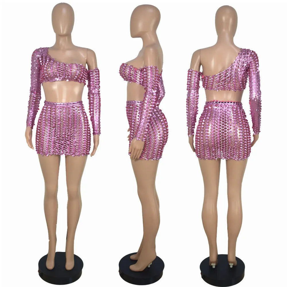 Women's black hollow-out net two-piece dress set featuring a sleeveless top and short skirt on a hanger.