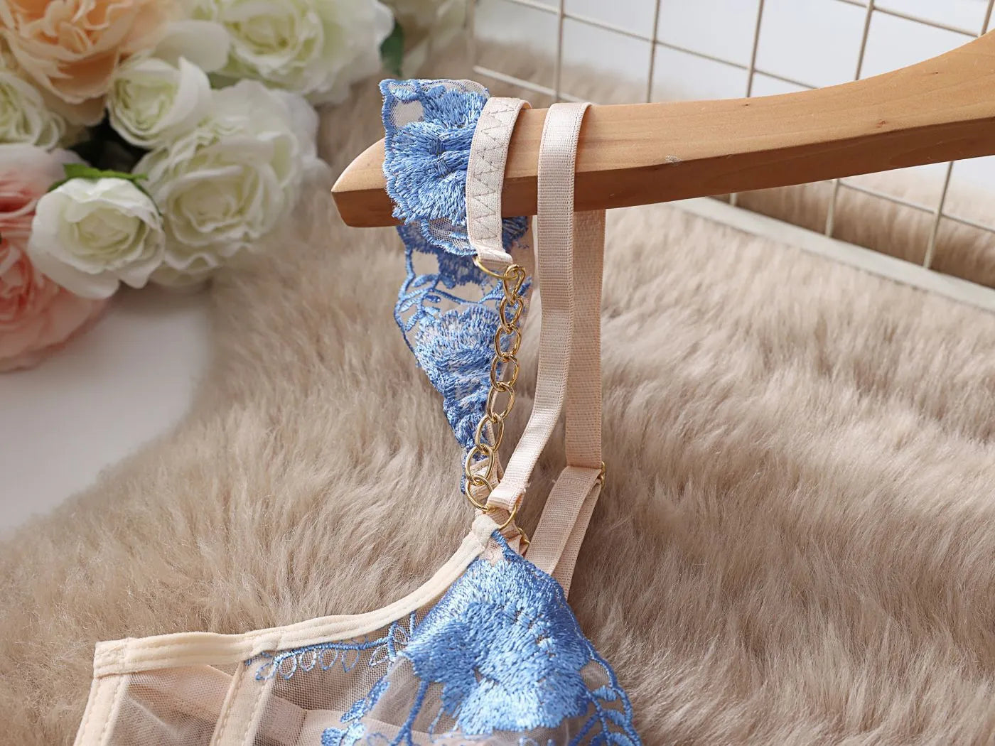 Light blue lace embroidered women's bra and pants set with transparent mesh design.