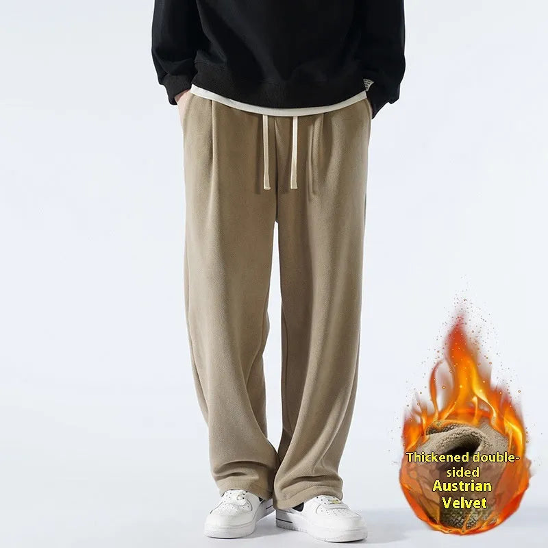 Men's apricot double-sided polar fleece winter trousers with a loose fit and drawstring waistband on a hanger.