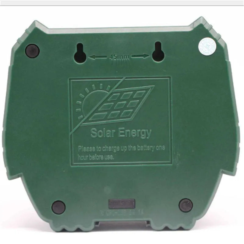Green solar-powered ultrasonic dog repeller with LED lights for outdoor animal deterrent.