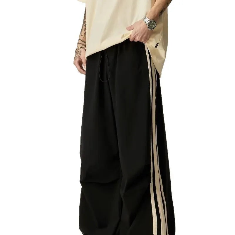 Black men's wide-leg climbing pants with a high waist and long straight-leg design on a neutral background.
