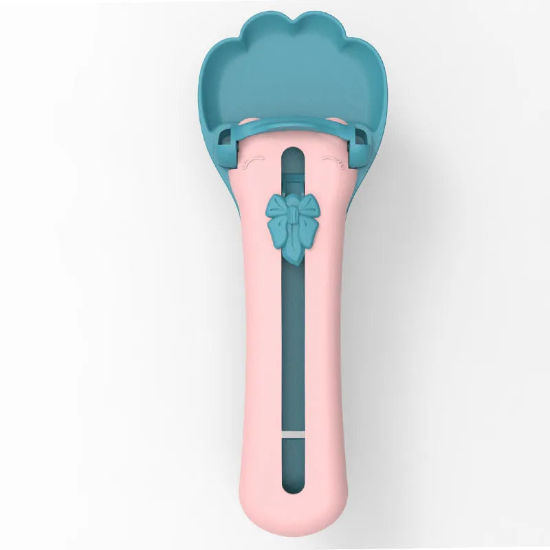 Green and pink pet feed spoon with extrusion design for liquid food and treat dispensing